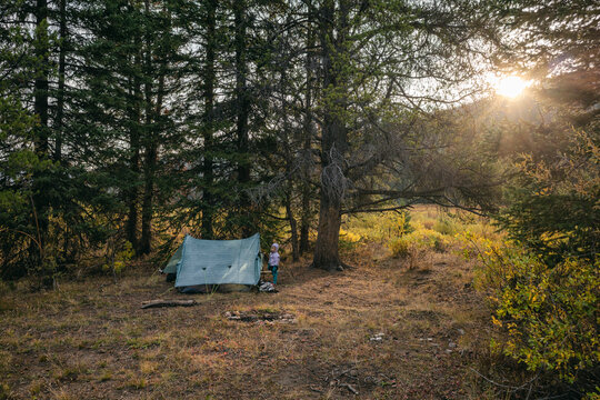 Young girl standing next to her tent in Colorado