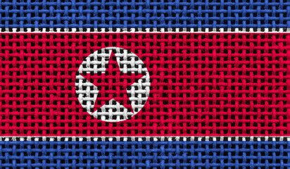 North Korea flag on the surface of a metal lattice. 3D image