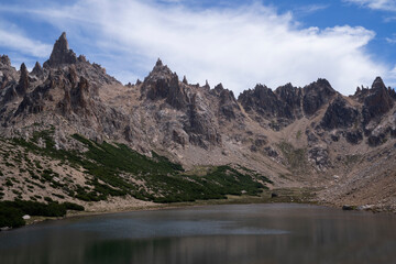 Alpine landscape. View of Toncek lake at the top of Catedral hill in Bariloche. The rocky mountains in the background.