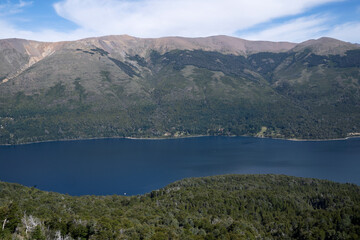 Fototapeta na wymiar View of the forest, blue water Gutierrez lake and Catedral hill in Bariloche, Patagonia Argentina. 