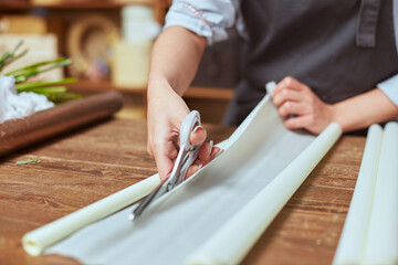Florist cutting wrapping paper for fresh bouquet