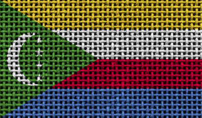 Comoros flag on the surface of a metal lattice. 3D image
