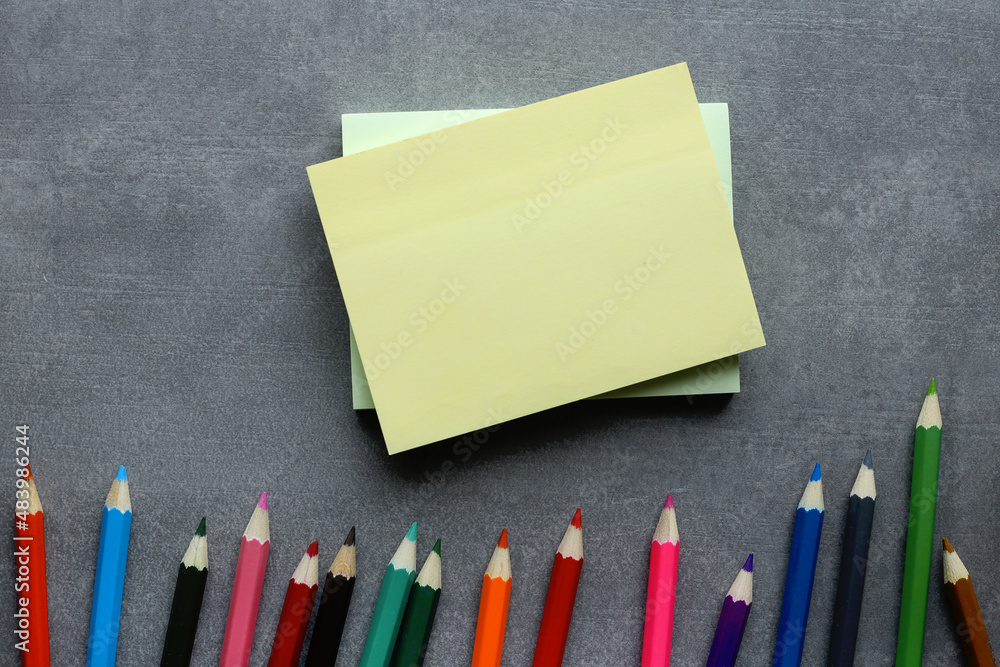Poster flat lay on a gray background with colorful pencils with copy space. financial or educational busine