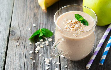 Smoothies. Apple banana smoothies with oatmeal on a light background. Healthy breakfast. Selective focus.