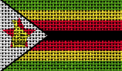 Zimbabwe flag on the surface of a metal lattice. 3D image