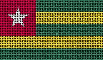 Togo flag on the surface of a metal lattice. 3D image