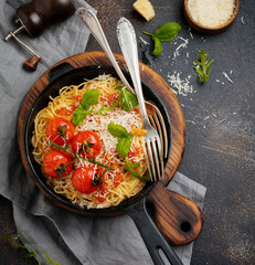 Pasta spaghetti. Traditional Italian dish of spaghetti with tomato sauce and parmesan cheese in ceramic plate on light concrete background. Selective focus. Top view.