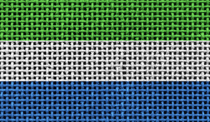 Sierra Leone flag on the surface of a metal lattice. 3D image
