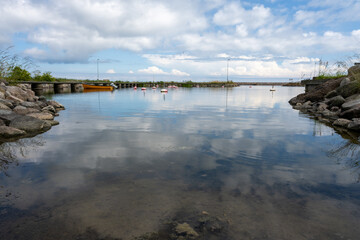 A blue sky with patchy clouds over a calm bay in the summertime. From the Swedish island Oland