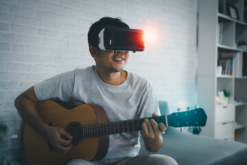 Asian man play guitar sing song and play VR game for entertain at home, asian man joyful in house...