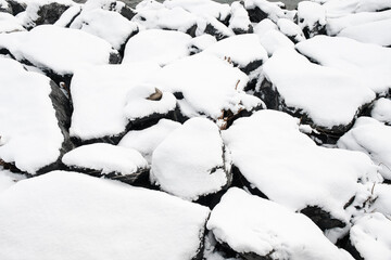 Stones in the snow. Pattern of snow and stones