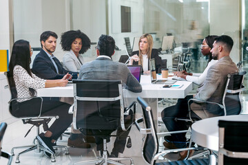 Business people discussing together in conference room during meeting at office in a modern startup. - Powered by Adobe