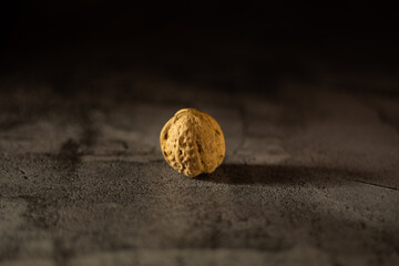 Walnuts on a dark background, One walnut
