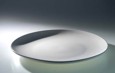 The flat white ceramic plate illuminated by a beam of light.