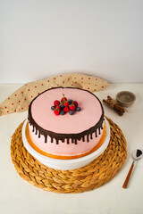 Homemade sponge cake with berries, pink cream and chocolate. Selective focus.