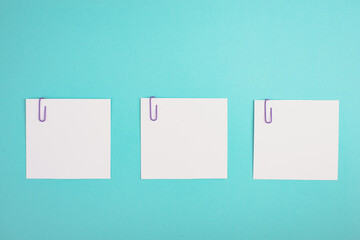 Empty white paper pinned on a blue colored background, bulletin note, rreminder,  empty copy space