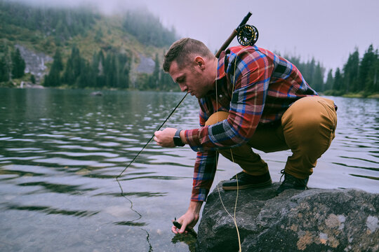 A flannel dressed fly fisherman lands a trout at Lake 22.