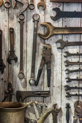 Maintenance and set of tools for motorbike and car on wooden background. Old rusty equipment.