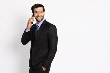 Naklejka premium Handsome young businessman in suit talking on smartphone isolated on white background