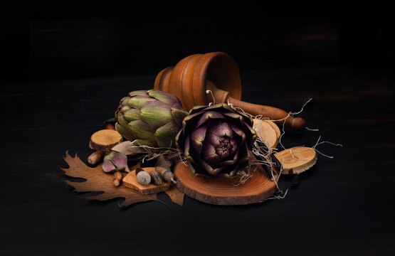 artichokes in a wooden mortar in dark atmosphere all focus
