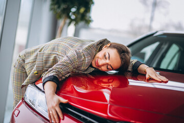 Beautiful woman hugging a car