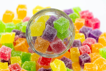 Cube jelly candy in container and the floor. Circle glass contained sweetie candy.