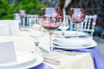 Table decorations for holidays and wedding dinner. Table set for holiday, event, party or wedding reception in outdoor restaurant.