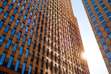 Modern office building with sky and sun