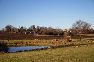 Spring rural landscape. Freshly plowed land. Arable land. Sowing work on the farm.