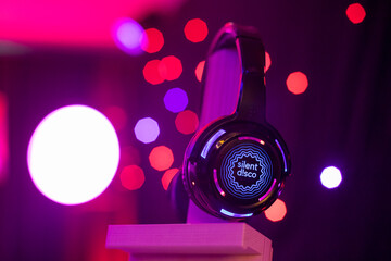 Silent Disco Headphone with red lights shining behind it at an event