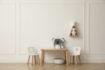 Cute child room interior with furniture, toys and wigwam shaped shelf on white wall