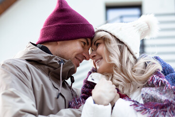 Portrait of two people couple fair-haired woman and man holding crossing hands together staring at each other outdoor
