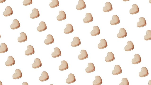 Motion graphics pattern with many heart shaped French vanilla macaroons cookies y for Valentines Day that Moving Diagonally on different sides on a white color background. Love template greeting card.
