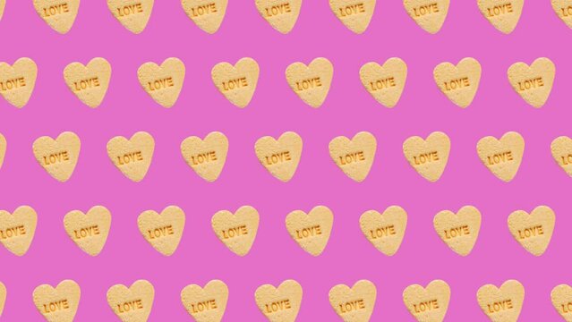 move different sides and size animations for 10 sec pattern made of  Sweet hearts shaped yellow Sugar Pill Candy on a trending ligh pink color background.omantic Love concept for St. Valentine's day.