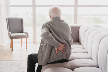 Senior old elderly man grandfather touching his back, suffering from backpain, sciatica, sedentary...