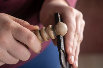 Fototapeta premium A tanner processes leather goods with a slicker.