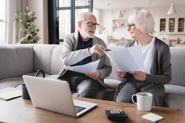 Senior old elderly grandparents couple family wife and husband counting funds, savings declarations, investments,paperwork, financial documents, bankruptcy, court case, bills, pension with laptop. - obrazy, fototapety, plakaty