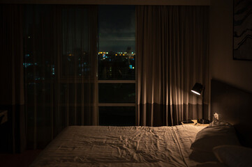 Empty bed with a view at night