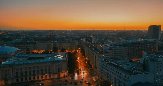 the sun sets over autumn bucharest. evening in a European city. urban active traffic in the old city - Aerial view Hyperlapse