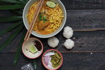 Khao Soi Recipe,Khao Soi,Khao Soi Kai, Thai Noodles Khao Soi, Chicken Curry with seasoning served on wooden table