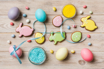 holiday preparation Multi colors Easter eggs with cookies on colored background . Pastel color Easter eggs. holiday concept with copy space