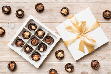 White box with chocolates candies and golden tape. top view with copy space