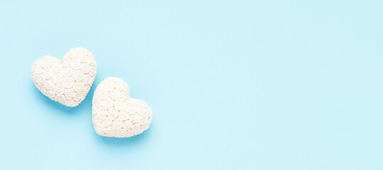 Valentines day background. Two white hearts on a light blue backdrop. Flat lay, banner, copy space