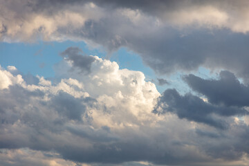 Cloud on blue sky background. Cloudscape grey and orange shade. Twilight light color the cloudy sky