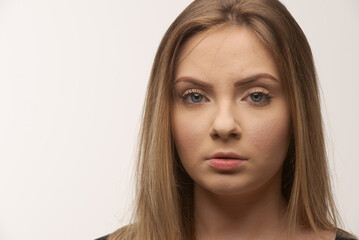 Portrait of sad young woman emotional alone in white background