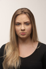 Naklejka premium Portrait of sad young woman emotional alone in white background