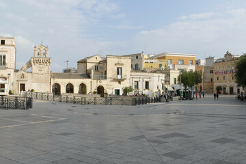 Fototapeta na wymiar Vittorio Veneto square in Matera with the Guerricchio viewpoint under the three arches, next to the Mater Domini church and in front of the Palombaro Lungo