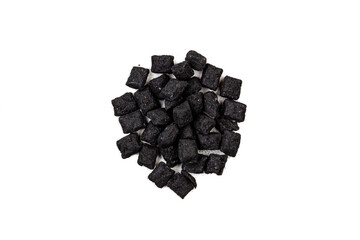 a pile of black incense isolated on a white background top view