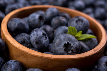 Fresh blueberries in a wooden bowl. Blueberry Antioxidant. Healthy and nutrition concept