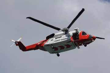 Fototapeten coast guard rescue helicopter in flight with door open © paultate